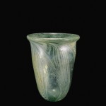 Beaker, transparent pale bluish greenish, free-blown with applied thread decoration. Rhineland, 5th-6th century. H: 6.7 cm.