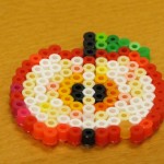 An apple created by fusing beads.