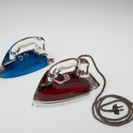 Silver Streak Iron Insert (blue) and Silver Streak Electric Iron (red), United States, Corning, NY, Corning Glass Works; Saunders Machine and Tool Corporation, made in 1946; designed in 1943; Blue: H: 11.7 cm, W: 21.6 cm, D: 9.6 cm; Red: H: 12.5 cm, W: 22.7 cm, W: 9.8 cm (65.4.3, gift of Otto Hilbert; 2005.4.22).