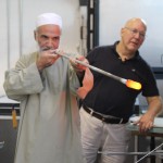 Mr. Nasrullah works with Bill Gudenrath to create glass.