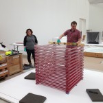 Carefully building Jun Kaneko's Glass Sticks. This sculpture is formed of 104 stacked glass bars, 26 on each side. Each bar consists of up to 10 layers of colorless and red glass.