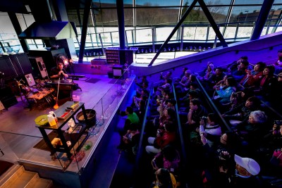 A tour group watches a Hot Glass Demo