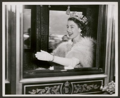 Princess Elizabeth waving from the royal carriage on her wedding day.