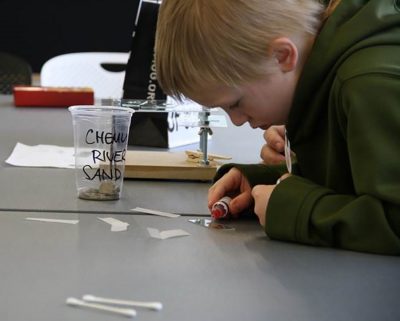 A maker stained his cheek cells red so they were more visible under the platform microscope he built. Visitors prepared specimen slides of flowers, fibers, and even insects.