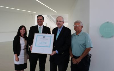 Lauren Staniec, board chair of the NY Upstate Chapter of the U.S. Green Building Council presents the certification to Alan Eusden, COO of CMoG; Jim Flaws, vice chairman of CMoG’s board, and former vice-chairman and CFO of Corning Incorporated; and Joe Dubendorfer, project manager for the new wing.