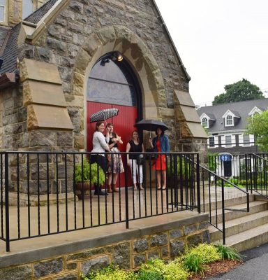 The group finds shelter from the rain before exploring the interior of Calvary Church.