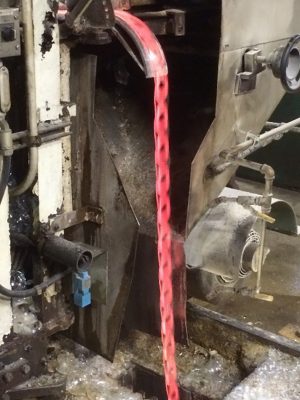 The remainder of the glass ribbon goes through the machine, and is recycled as cullet that is used to produce more glass fed into the ribbon machine.