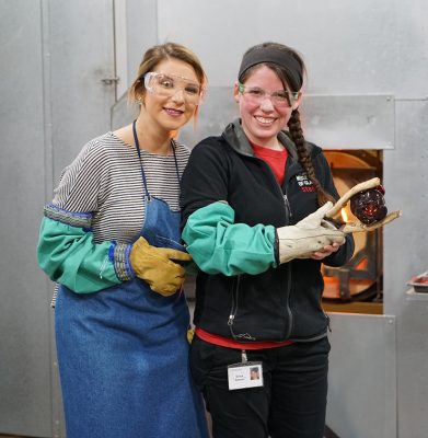 Tess and Erica with the rose just before it goes into the annealer for cooling.