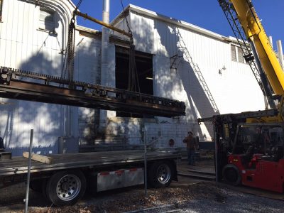 Section of the Ribbon Machine being loaded onto a flatbed trailer for transport