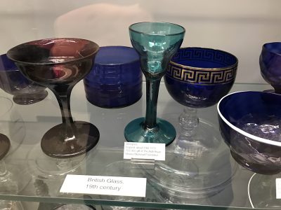 Deep blue gilded bowl on British Glass 19th century shelf.