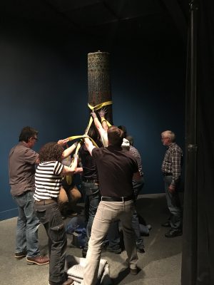 The column is moved into its home and secured into place.