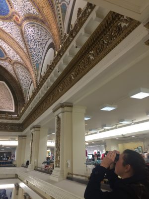 Kelly Conway views the mosaic dome through binoculars at Macy's (formerly Marshall Field & Company) in Chicago.