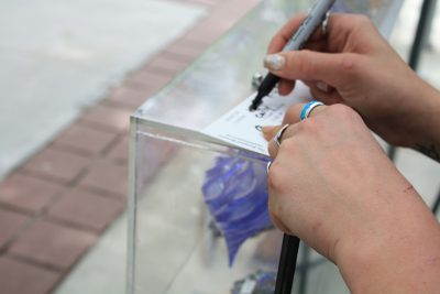 A Make Your Own Glass instructor taking down notes on color choices.