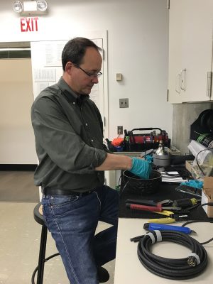 Dave Kuentz, Preparator, rewiring and replacing bulbs.