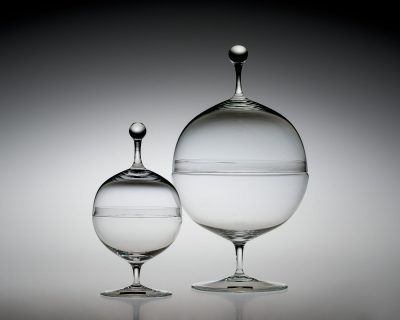 Candy Dishes, designed in 1925. Designed by Oswald Haerdtl (Austrian 1899–1959); manufactured by J. & L. Lobmeyr. Glass, mold-blown, tooled, ground and polished. H. 22.9 cm, Diam. 12.7 cm; H. 15.3 cm, Diam. 7.7 cm. The Corning Museum of Glass (64.3.43).