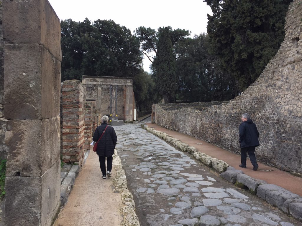 Exploring the remains of the ancient city of Pompeii, buried by the eruption of Mt. Vesuvius in A.D. 79.