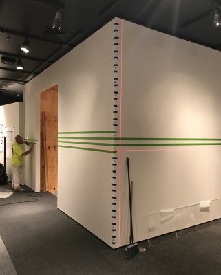 Painting the wall stripes in the exhibition.