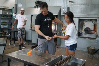 Instructor Ross Delano helps student Ivy Velez with her marvering technique.