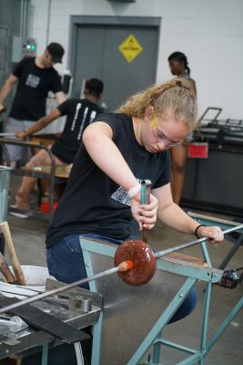 Student Nikki Baldwin works on her pumpkin project.