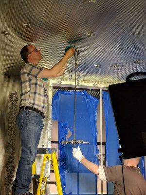 Preparator and resident electrician Dave Kuentz and MAK’s Harald Bauer complete installation of the chandelier.