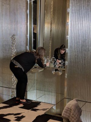 Assistant curator Alexandra Ruggiero arranging Hoffmann’s glass vessels at the dressing table.